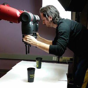 A team member adjusting the robot's arms.